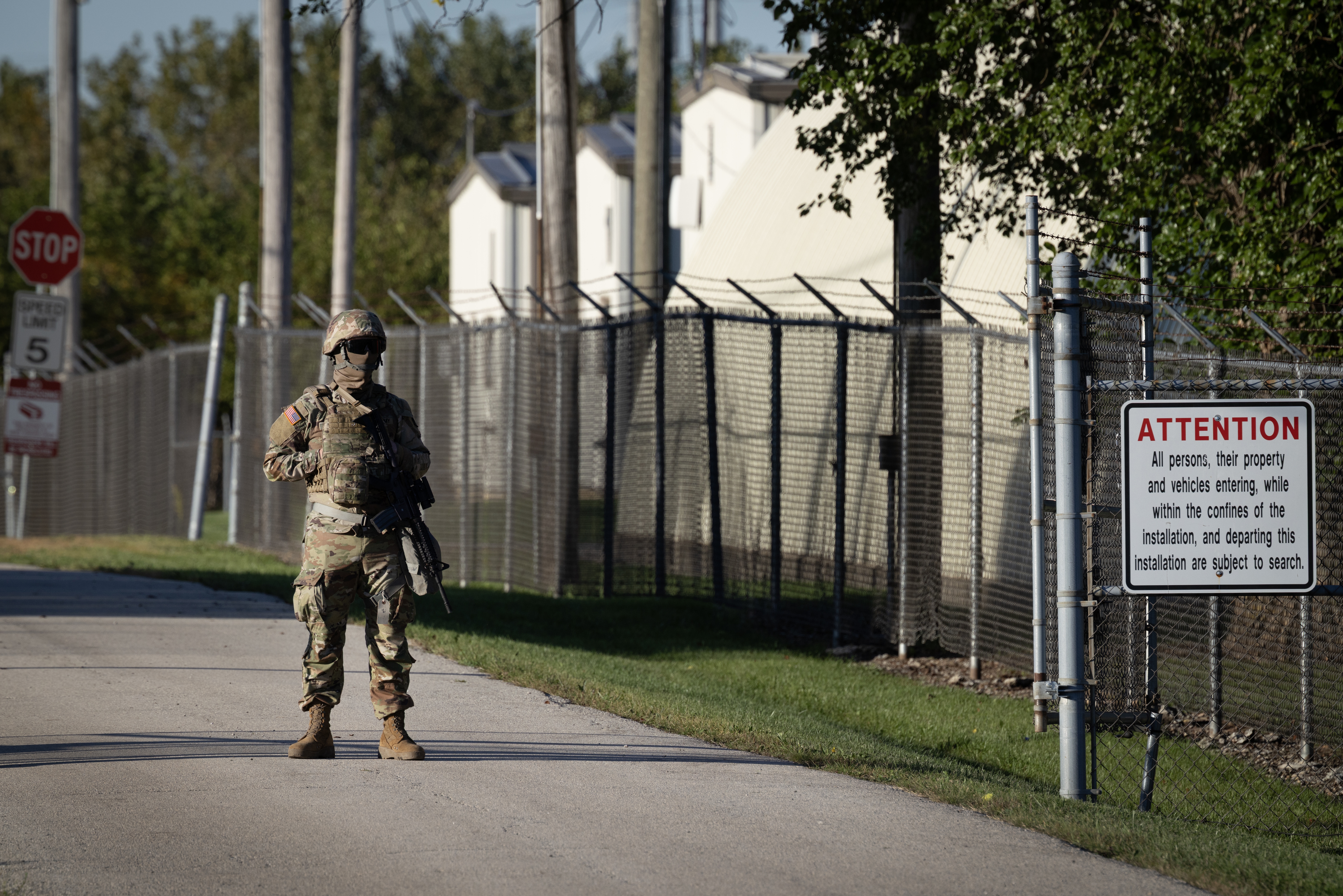 A member of the Texas National Guard stands at an army reserve training facility on October 07, 2025 in Elwood, Illinois.